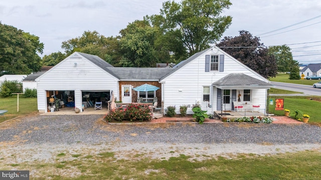 view of front of house with covered porch and an outbuilding