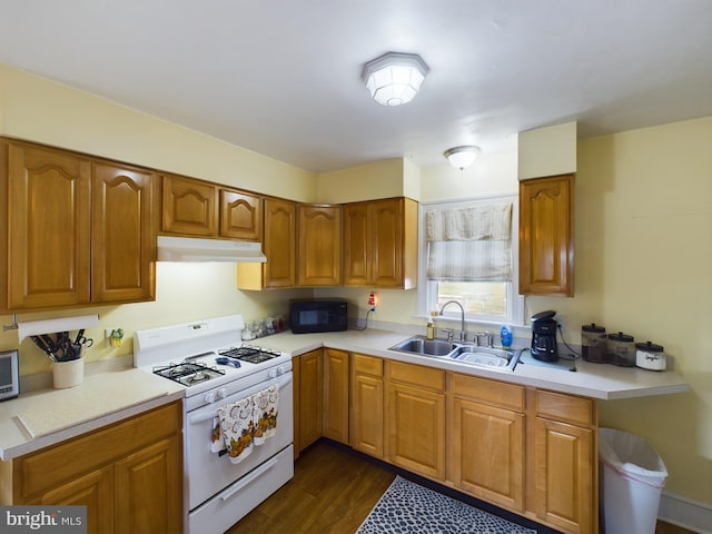 kitchen with sink, white range with gas stovetop, and dark hardwood / wood-style flooring