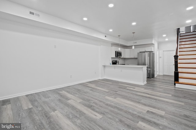 unfurnished living room with light hardwood / wood-style flooring