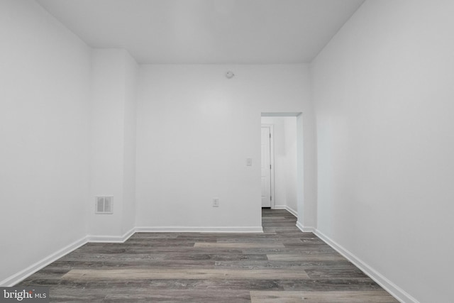 unfurnished room with dark hardwood / wood-style flooring