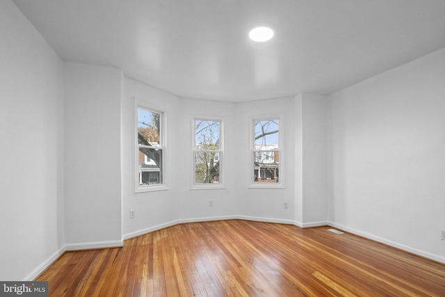 empty room with wood-type flooring