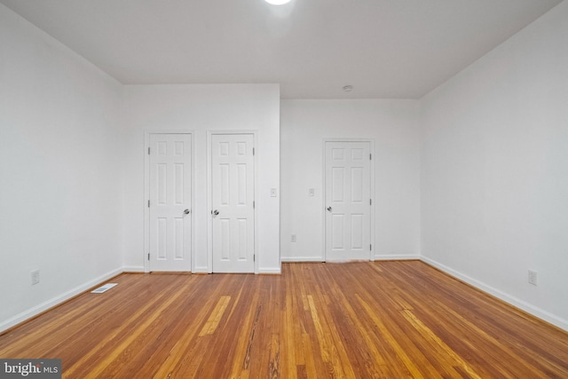 unfurnished bedroom featuring hardwood / wood-style floors