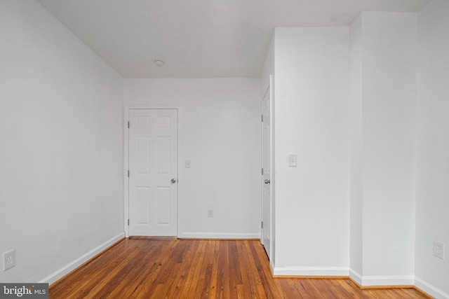 unfurnished room with hardwood / wood-style floors