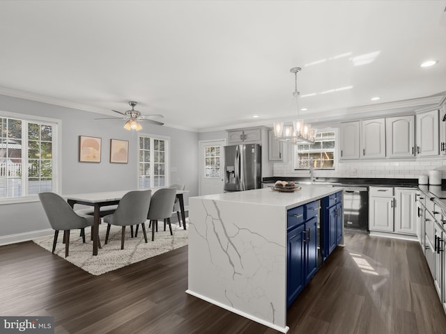 kitchen featuring blue cabinets, stainless steel fridge with ice dispenser, decorative light fixtures, and white cabinetry