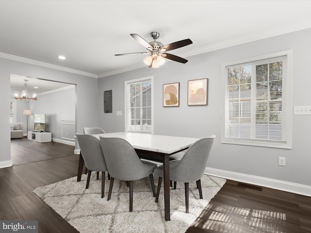 dining space featuring ornamental molding, electric panel, dark wood-type flooring, and ceiling fan with notable chandelier