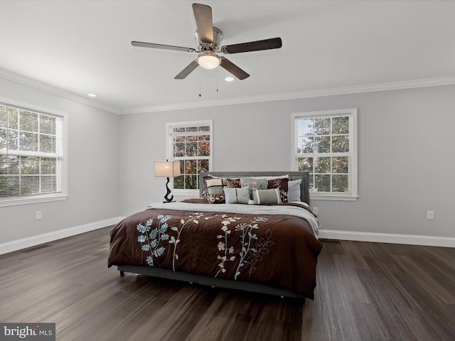 bedroom with crown molding, dark hardwood / wood-style floors, and ceiling fan