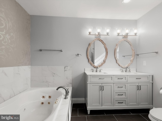 bathroom with toilet, a relaxing tiled tub, vanity, and tile patterned floors