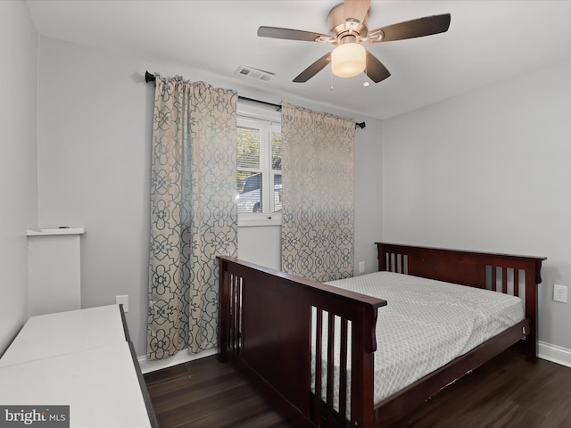 bedroom with dark wood-type flooring and ceiling fan