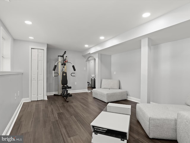 exercise room with dark wood-type flooring