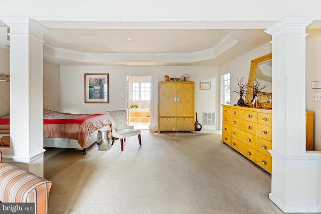 bedroom with multiple windows, a raised ceiling, and ornate columns