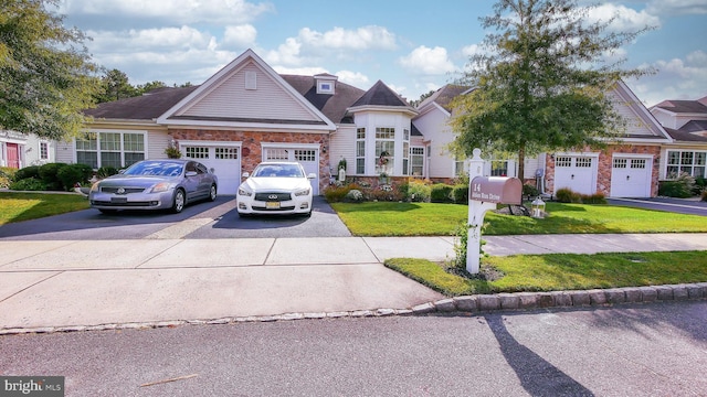 view of front of home featuring a garage and a front lawn