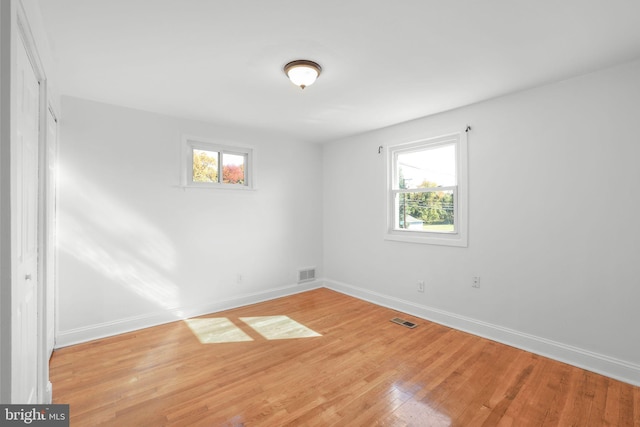 empty room with light hardwood / wood-style floors