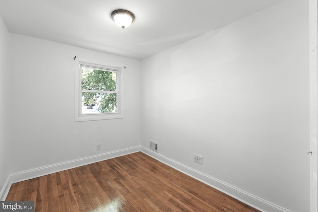 unfurnished room with dark hardwood / wood-style floors