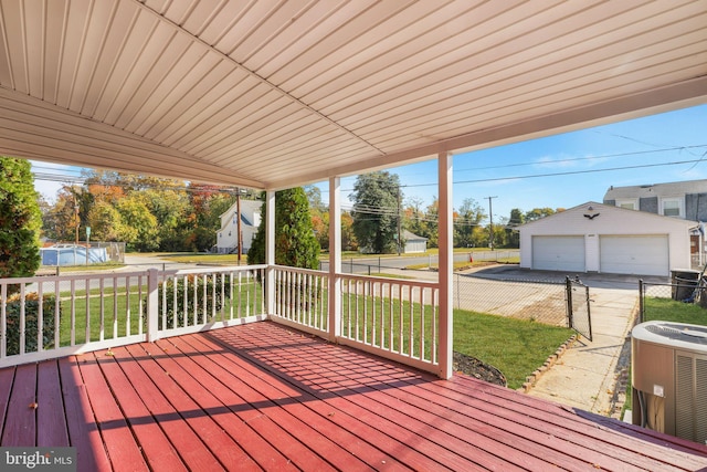 wooden deck featuring an outbuilding, central AC, a yard, and a garage