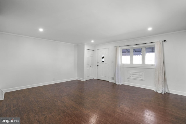 foyer featuring crown molding and dark wood-type flooring