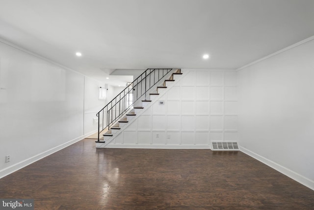 basement with crown molding and dark hardwood / wood-style floors