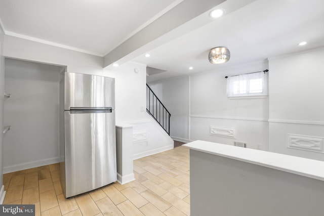 kitchen with light hardwood / wood-style floors and stainless steel refrigerator