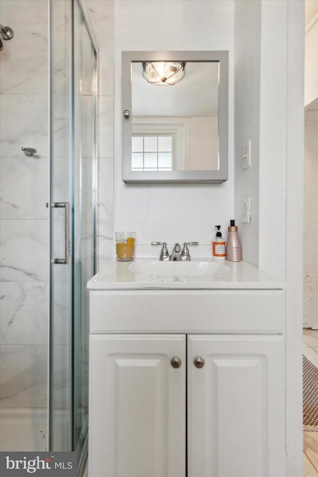 bathroom featuring walk in shower and vanity