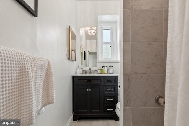 bathroom with vanity, tile patterned flooring, and toilet