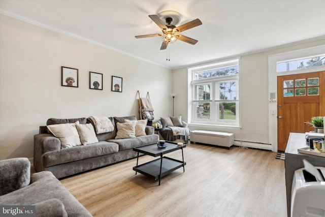 living room with light wood-type flooring, ornamental molding, a baseboard heating unit, and ceiling fan