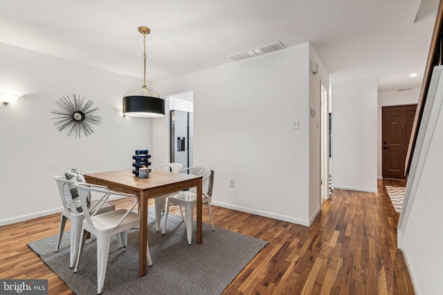 dining space with dark wood-type flooring