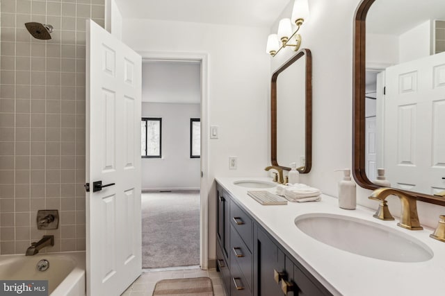 bathroom featuring tiled shower / bath, vanity, and tile patterned flooring