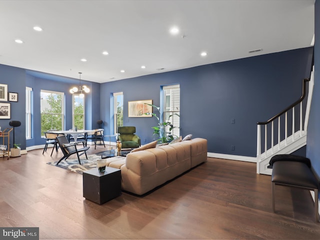 living room featuring hardwood / wood-style flooring and a notable chandelier