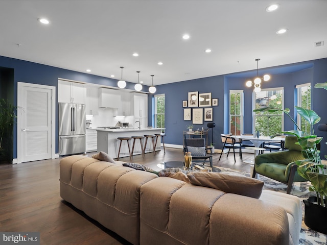 living room with dark hardwood / wood-style flooring and plenty of natural light