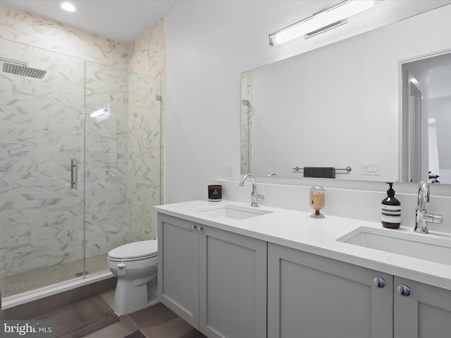 bathroom with tile patterned flooring, vanity, toilet, and an enclosed shower