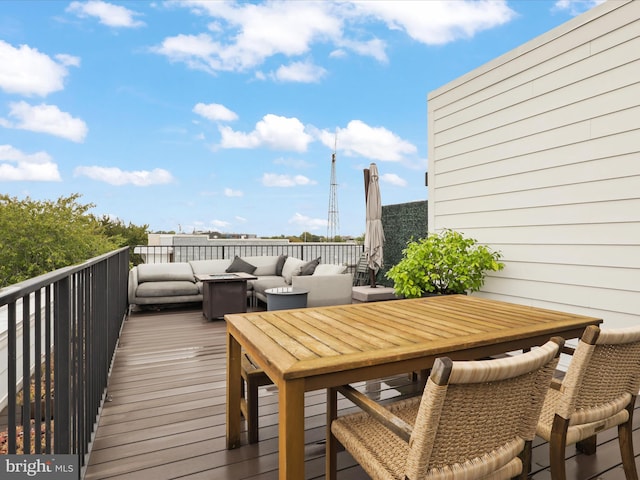 wooden terrace featuring an outdoor living space