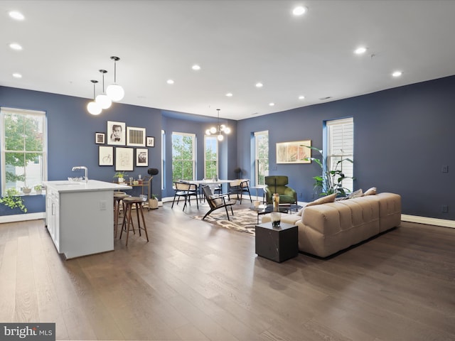 living room featuring an inviting chandelier and wood-type flooring