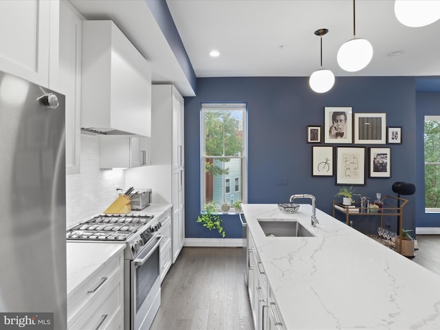 kitchen featuring light stone counters, pendant lighting, sink, white cabinetry, and stainless steel appliances