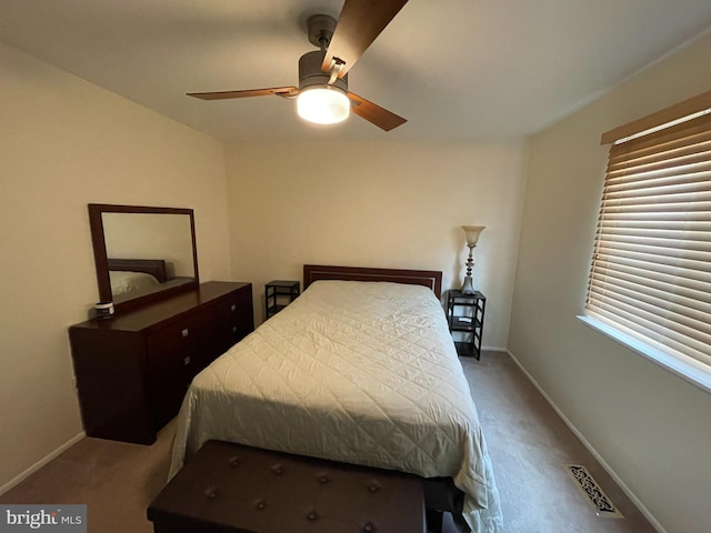 bedroom featuring carpet floors, visible vents, and baseboards