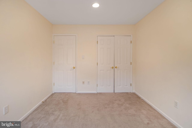 unfurnished bedroom with carpet floors, baseboards, a closet, and recessed lighting