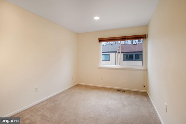 empty room with carpet, visible vents, baseboards, and recessed lighting