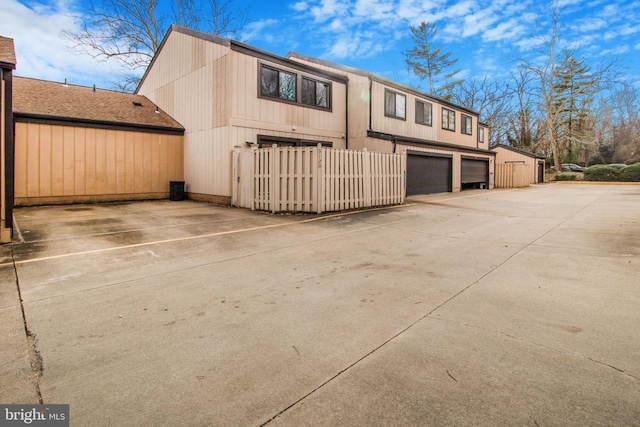 view of front of property with driveway and fence