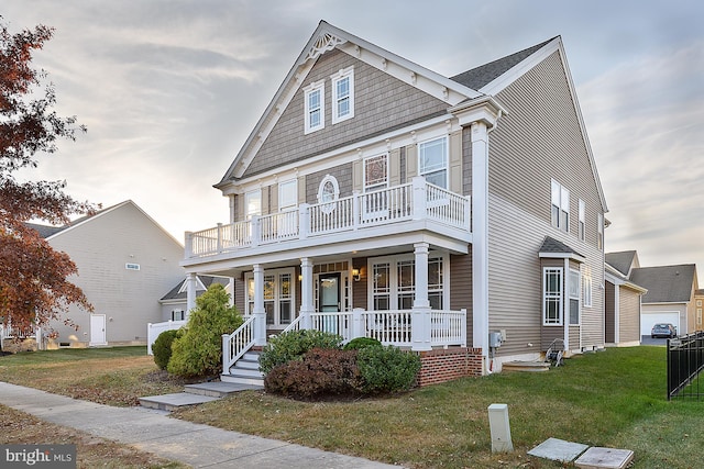 view of front of house featuring a front yard, a porch, and a balcony