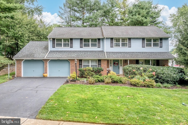 view of front of home featuring a garage and a front lawn