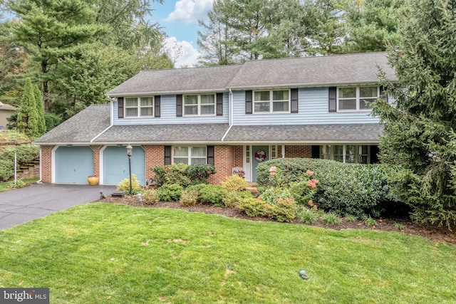 view of front property featuring a garage and a front lawn