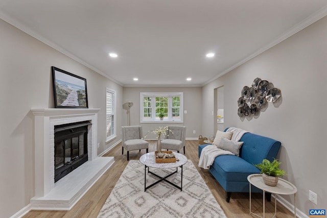 living room with light hardwood / wood-style flooring and ornamental molding