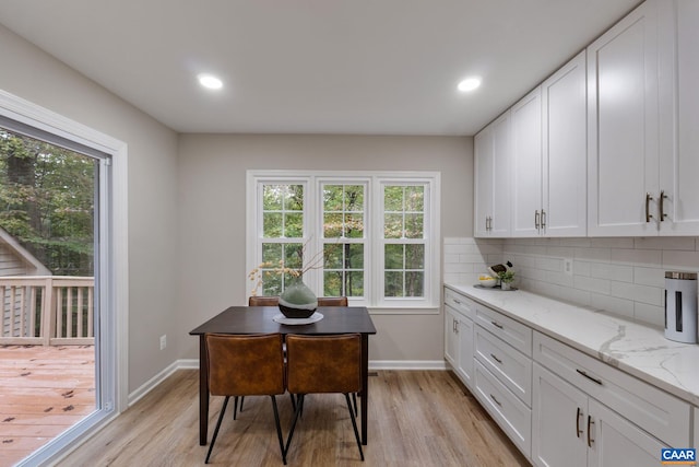 office with light hardwood / wood-style flooring and plenty of natural light