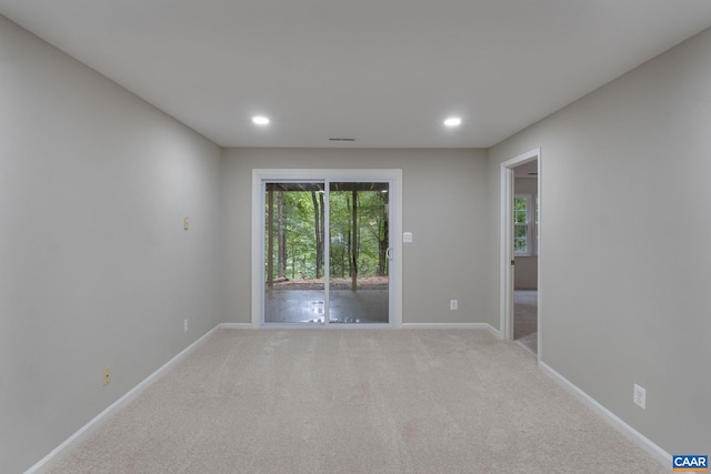 unfurnished room featuring light colored carpet