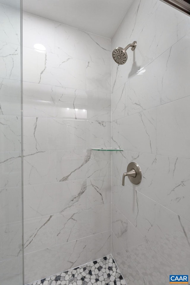 bathroom with tiled shower