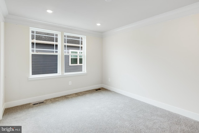 empty room with ornamental molding and carpet floors