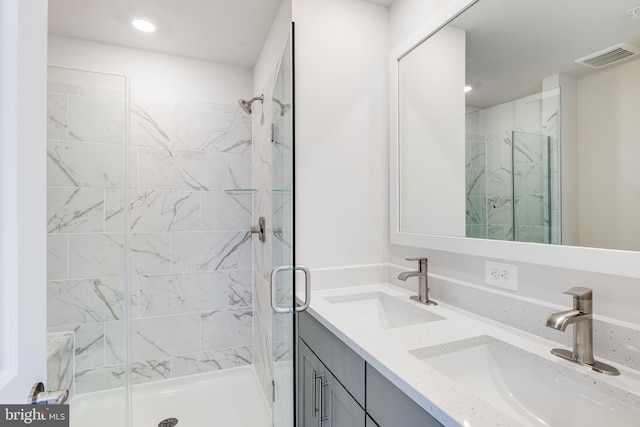 bathroom with vanity and a shower with shower door