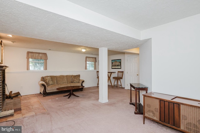 living area featuring light carpet and a textured ceiling