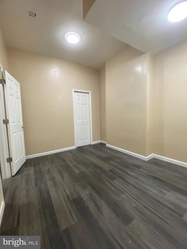 empty room featuring dark wood-type flooring