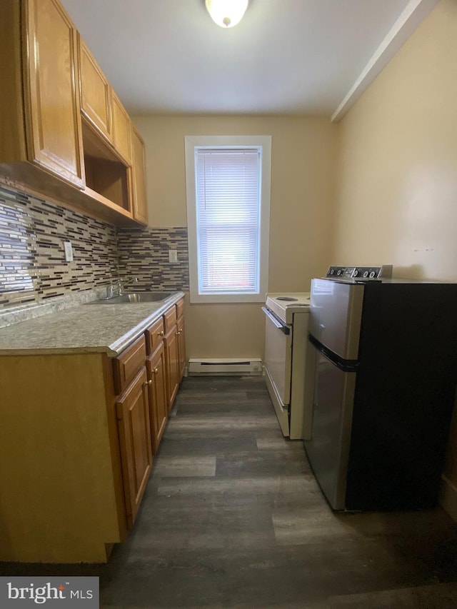 kitchen with stainless steel fridge, sink, backsplash, a baseboard heating unit, and dark hardwood / wood-style flooring