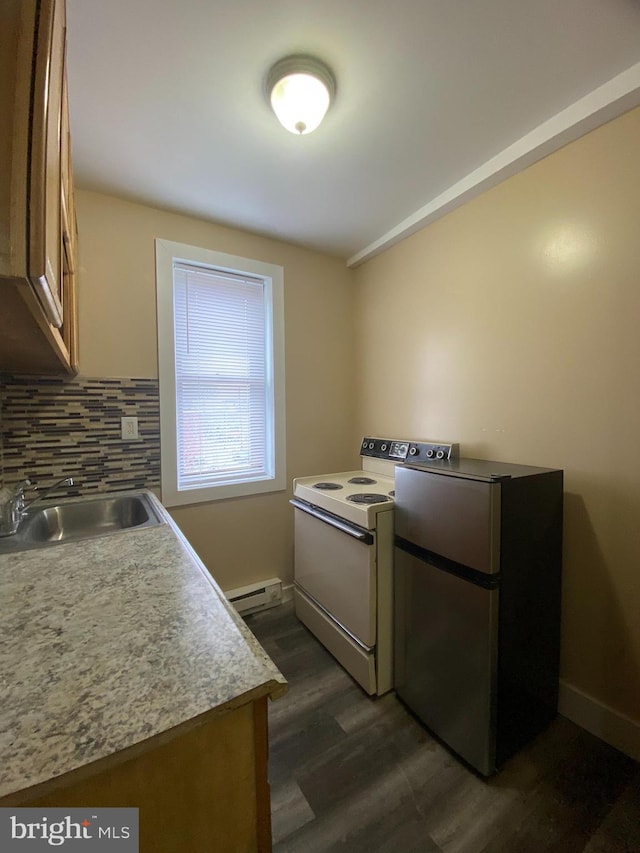 kitchen featuring white electric range oven, stainless steel fridge, sink, a baseboard heating unit, and dark hardwood / wood-style flooring