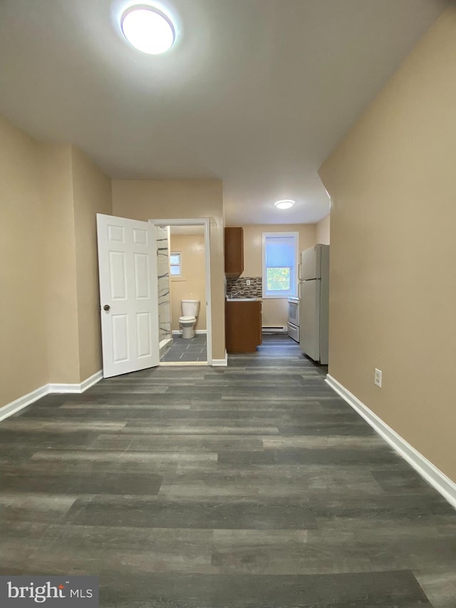 unfurnished living room featuring dark wood-type flooring